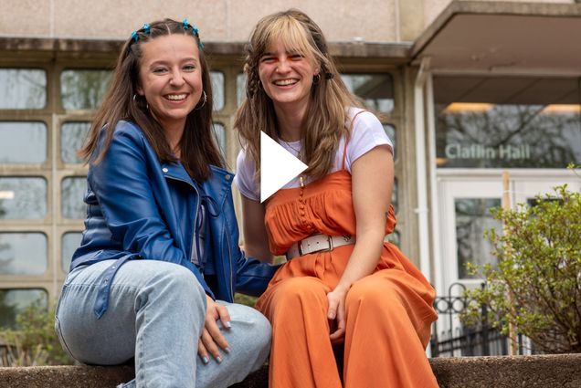 Maria Ordoñez and Manon Michel sitting next to one another smiling. A white video button is overlayed.