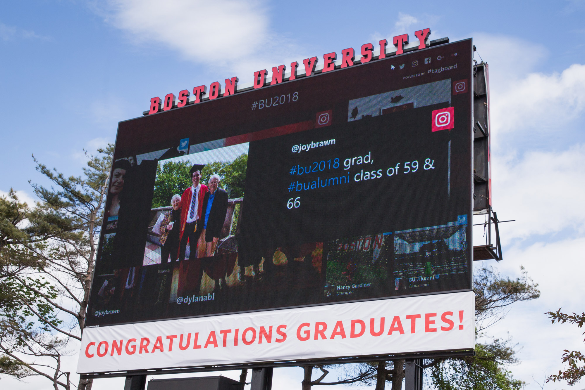 A photo of the jumbotron at Nickerson Field showing well wishes to graduates