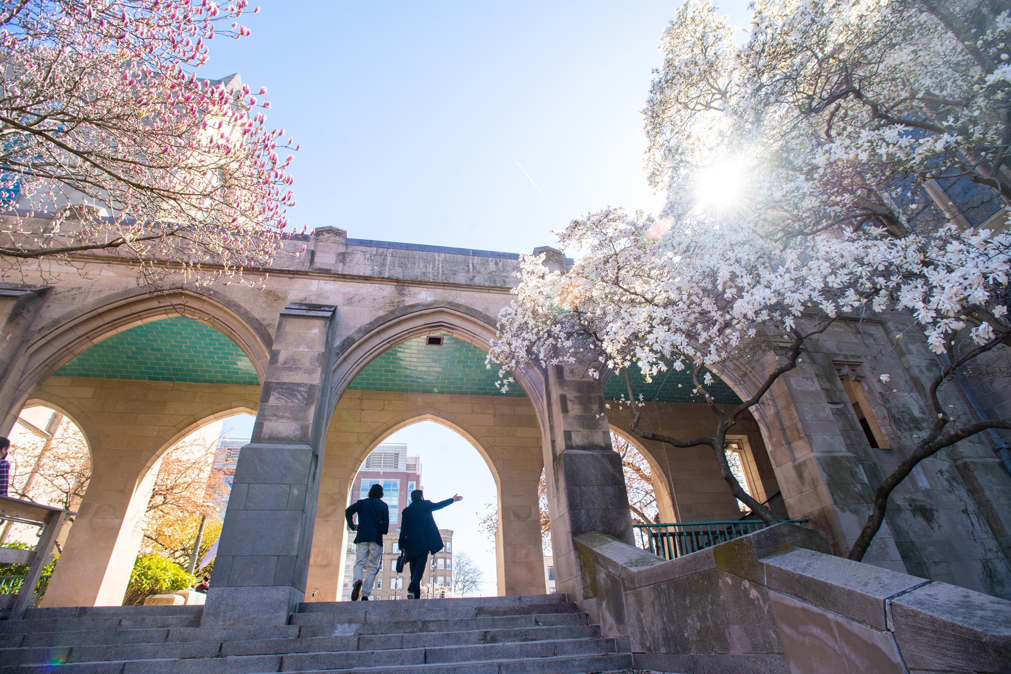 A photo of people walking up the stairs from BU Beach toward Marsh Chapel