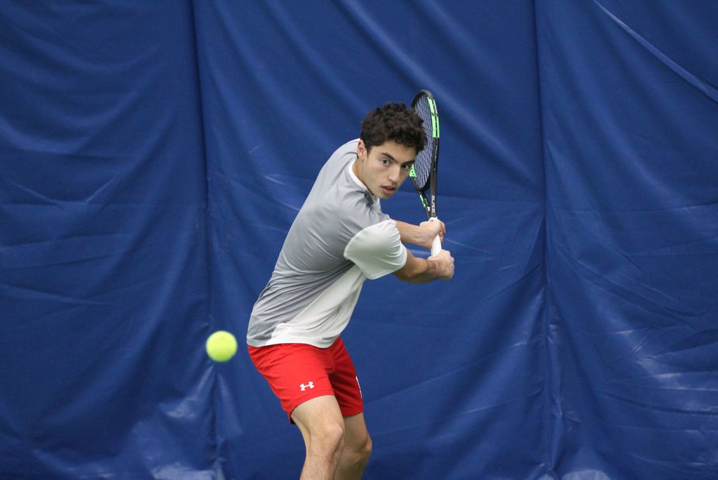 A photo of David Bogatin on the tennis court swinging a racket