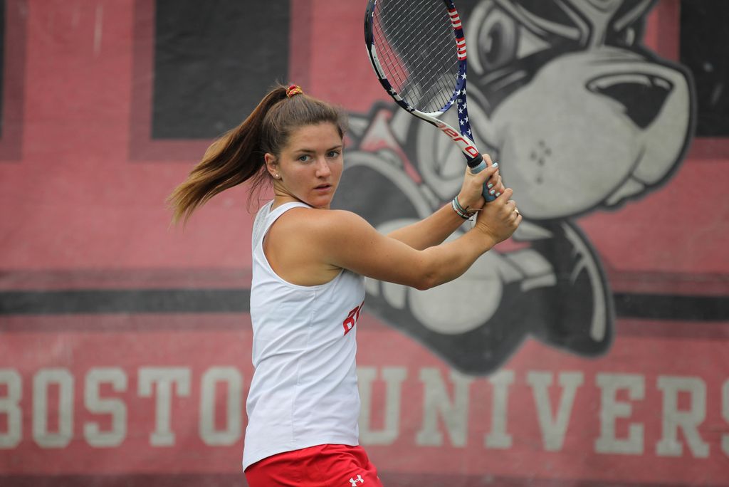 A photo of Lily Burchell on the tennis court swinging a racket