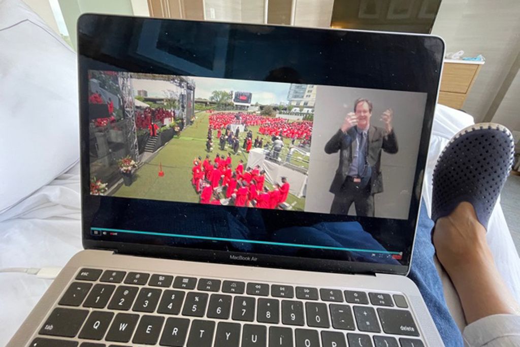 A photo of Claire and Gary Gelfman watching the commencement ceremony from their hotel room