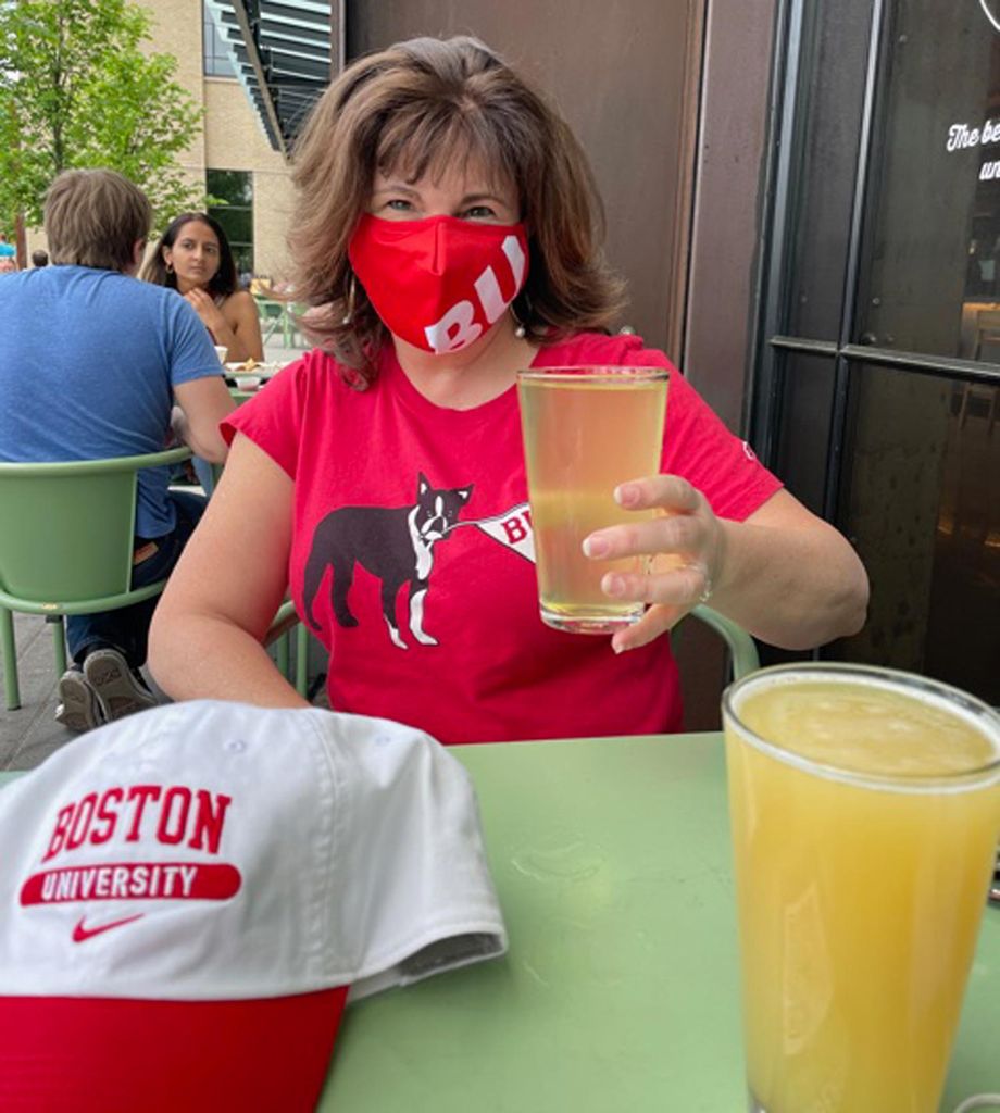 A photo of Peggy Karman holding a beer glass up in a toast