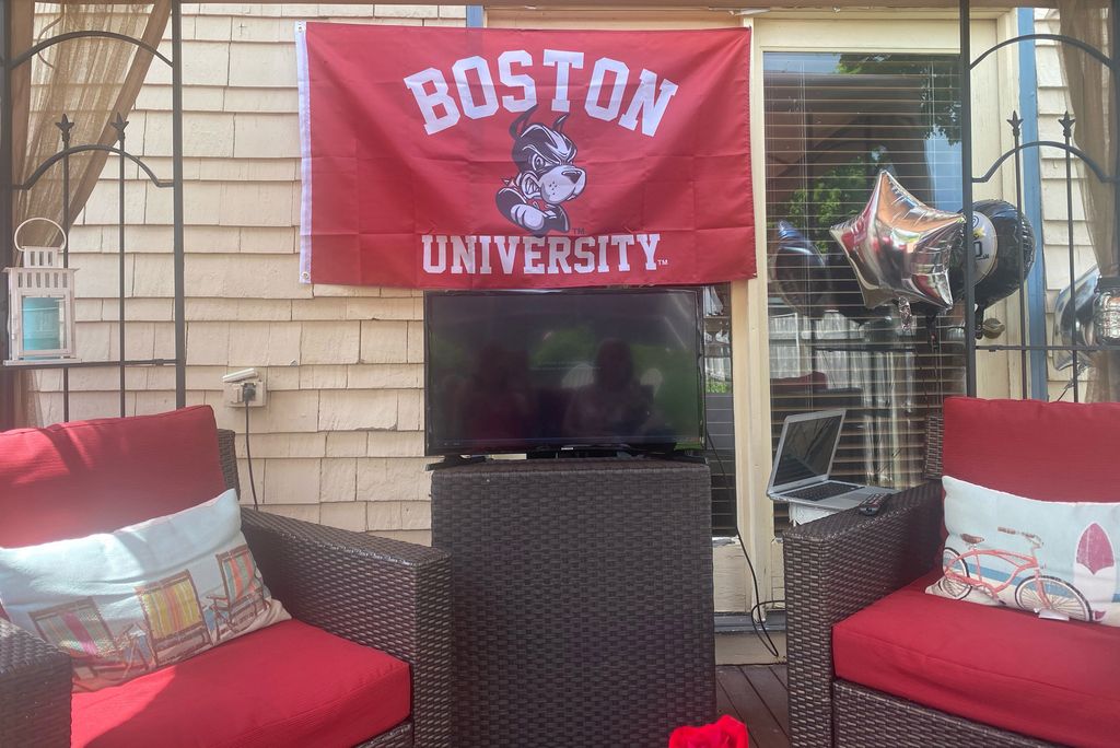 A photo of the Cole family watching commencement from their back yard