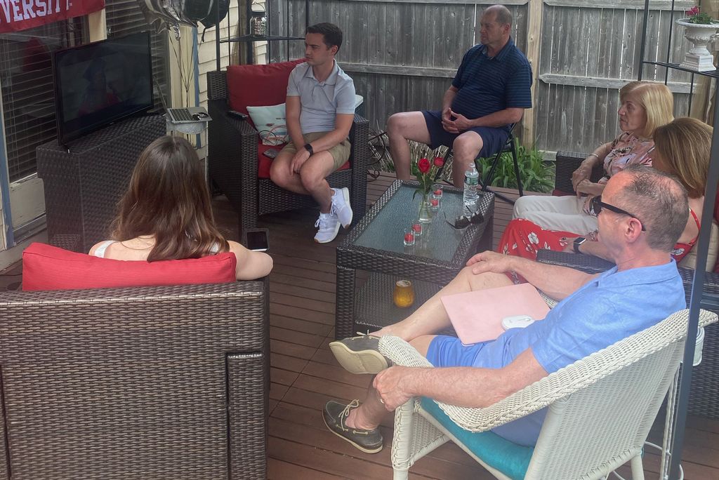 A photo of the Cole family watching commencement from their back yard