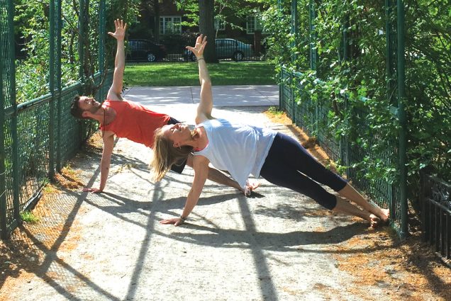 Two people doing side planks