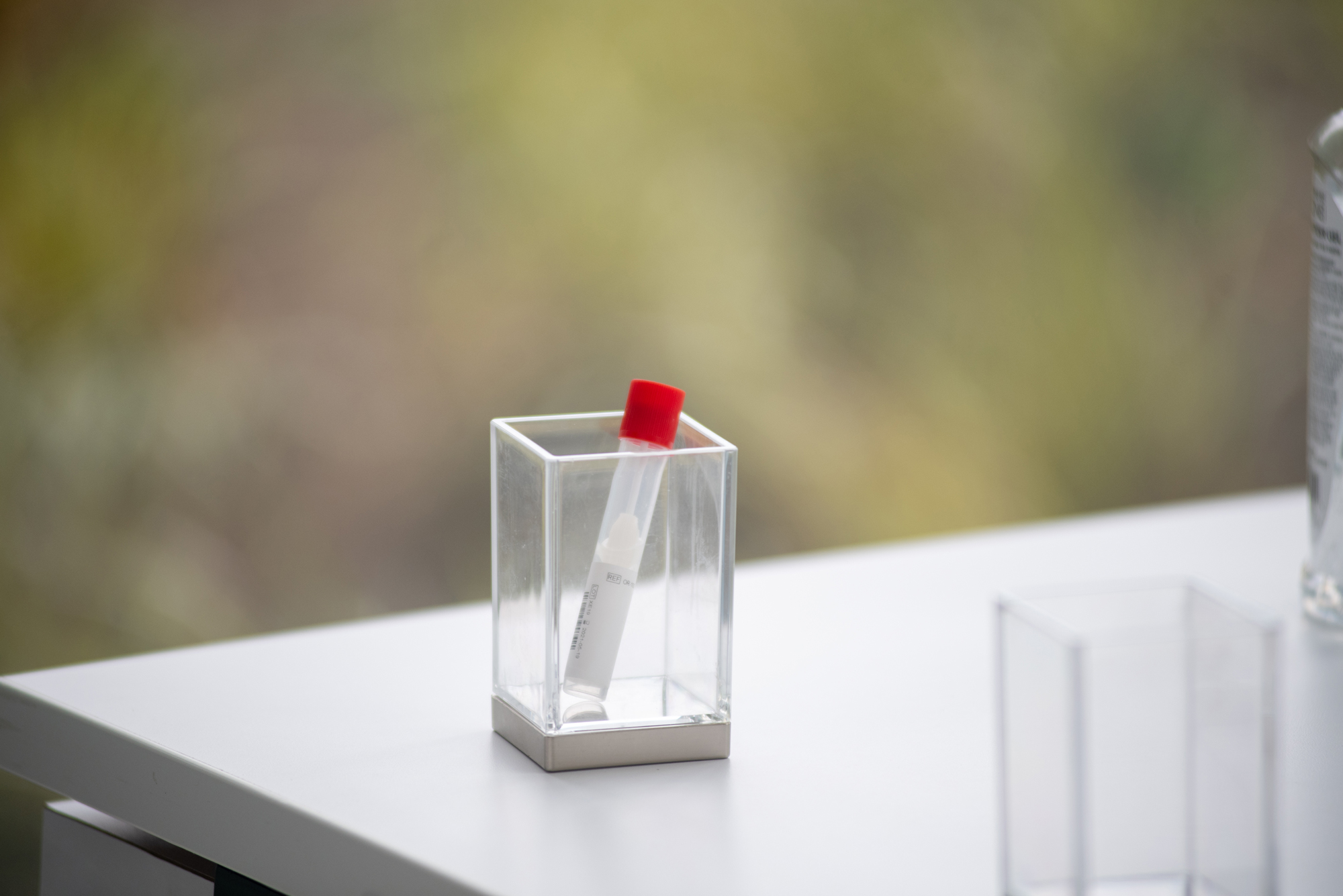 Photo of a single covid test vial with a swab in it with a red cap at the test collection at the Rajen Kilachand Center August 25, 2020.