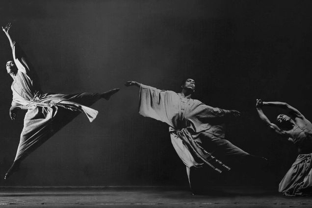 Black and white photo of a Black dancer in three different poses, on the left he jumps and stretches his arms and legs, in the middle he extends his arms, on the right he kneels and extends his arms over his head.