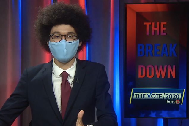 Screenshot from a broadcast done by Elias Miller (COM’21), who was one of the anchors of BUTV10’s three-day presidential election coverage The Vote 2020, a sign for the series is seen behind him on the right. He wears a blue face mask and a suit as he speaks towards the camera.