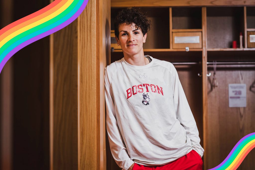 Kelly Lawrence, women’s assistant head soccer coach, poses for a photo on June 19, 2021. She wears a white long sleeve boston university sweatshirt and has her hands in her pockets.