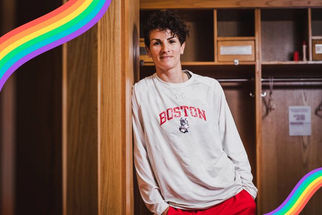 Kelly Lawrence, women’s assistant head soccer coach, poses for a photo on June 19, 2021. She wears a white long sleeve boston university sweatshirt and has her hands in her pockets.