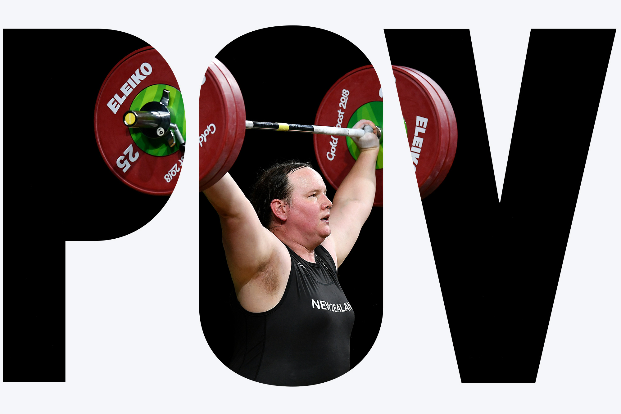 Photo of Laurel Hubbard of New Zealand as she competes in the women’s +90kg weightlifting final on April 9, 2018 at the Commonwealth Games in Gold Coast, Australia. She wears a black body suit and lifts a large barbell with green and red weights over her head. Overlay reads "POV"