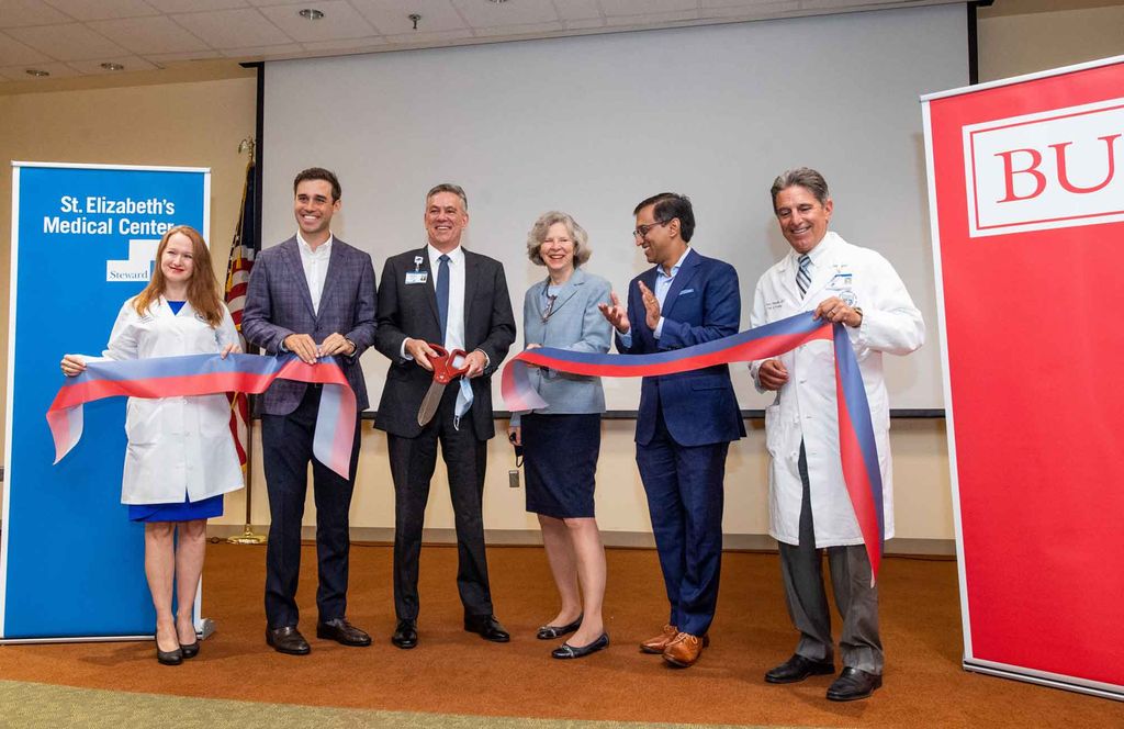 Anna Hohler, Harrison Bane, James Terwilliger, Karen Antman, Sanjay Shetty, and Frank Pomposelli cut a ribbon at St. Elizabeth's Medical Center sympbolizing the start of a 5 year agreement adding St. Elizabeth's as a training hospital for the Boston University School of Medicine.