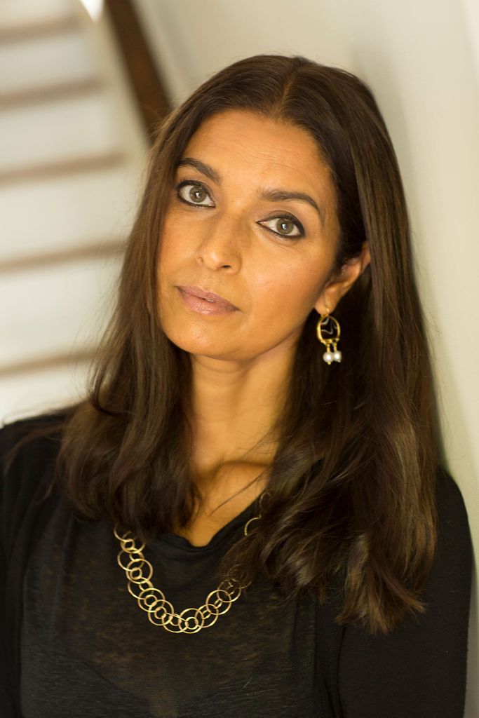 Headshot of Jhumpa Lahiri in a black blouse, gold necklace and earrings.