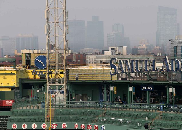 Thick haze from wildfire smoke in New England is shown hanging over the Boston skyline as viewed from Fenway Park.