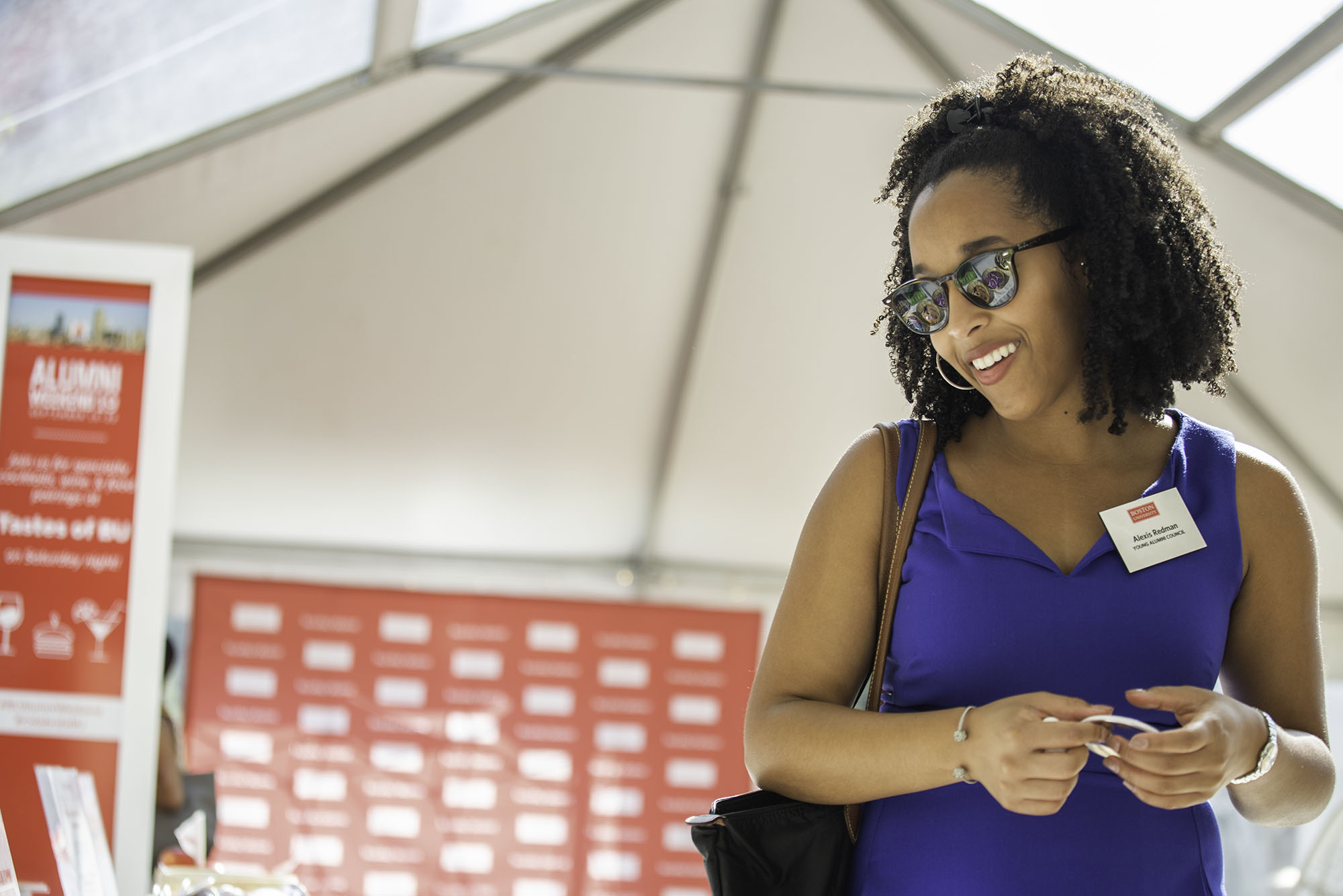 A BU Alum smiles as she checks in on campus