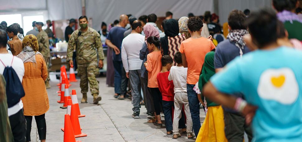 Afghan refugees line up for food in a dining hall at Fort Bliss' Doña Ana Village, in New Mexico, where they are being housed.