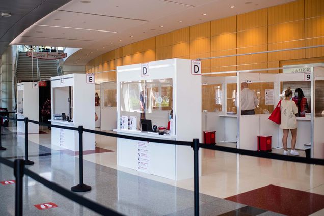 Wide view of the COVID-19 testing site at Agganis Arena, Boston University. A BU community member takes a nasal swab test in the back of the photo.