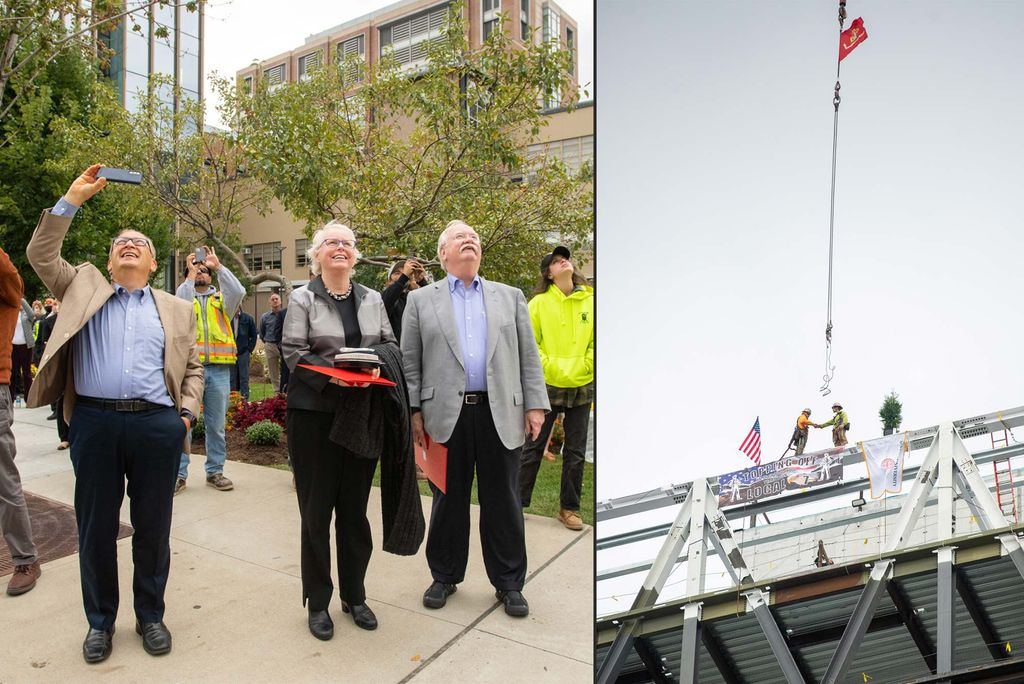 At left, Onlookers including President Robert A Brown, from right, Provost Jean Morrison, and Azer Bestaveros watch as the final beam is put into place during the Topping Off ceremony at the Data Sciences Building September 30. At right, .Covered in signatures, the final beam is put into place during the Topping Off ceremony. A large beam is guided into place by two construction workers on top of the building. The sky is grayish blue.