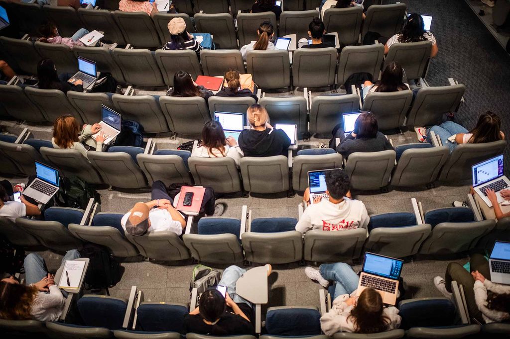 View looking down on students in a lecture hall during class at the College of General Studies.