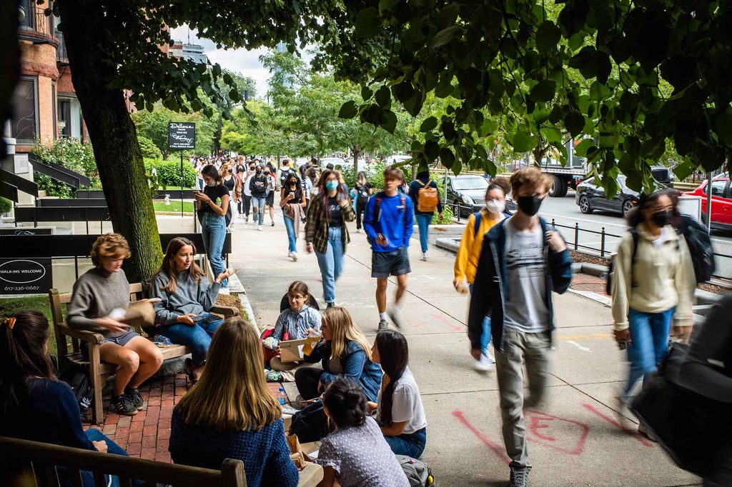 Boston University students sit and walk through George Sherman Union Plaza.