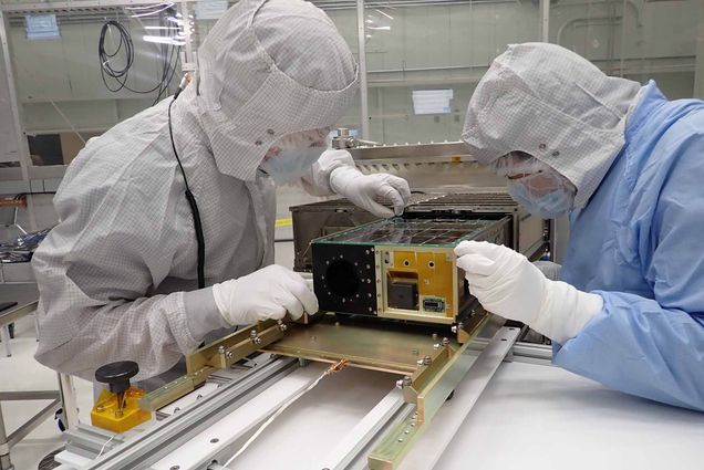 BU engineers Brian Walsh and Emil Atz work on the Cusp Plasma Imaging Detector (CuPID) satellite which uses a new kind of optical technology to enable wide-field X-ray imaging of magnetic fields from inside a shoebox-size package.