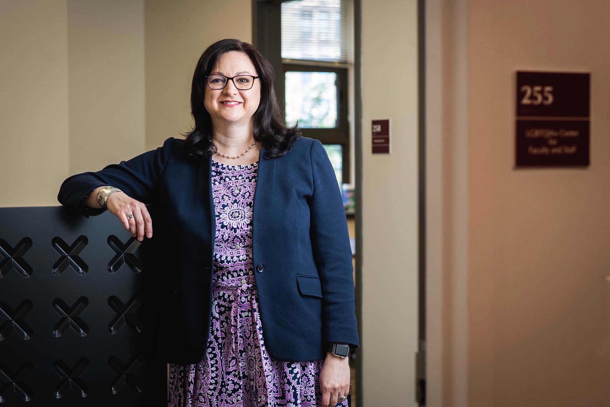 Portrait of Debbie Bazarsky, Inaugural Director of Boston University’s New LGBTQIA+ Center for Faculty & Staff, in her office.