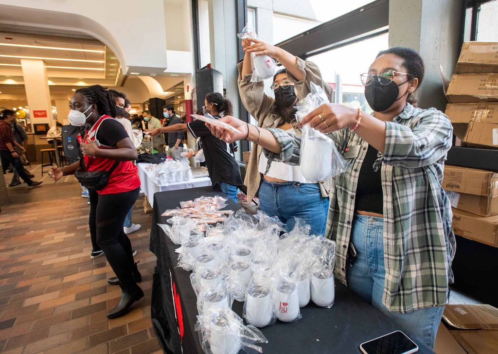 Students hand out free cups and cookies from the Student Activities Office at the First Day Festival, Boston University George Sherman Union.