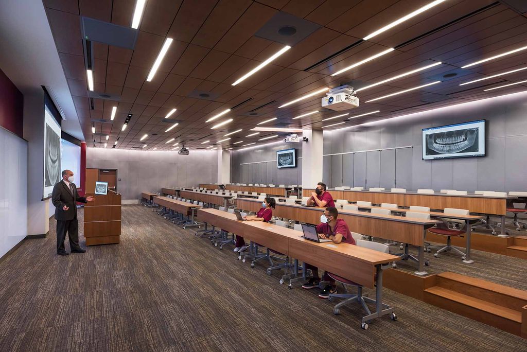 Students listen to a lecture in the new first-floor lecture hall at the Goldman School of Dental Medicine