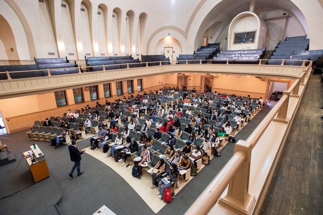 Wide elevated view of Uwe Beffert teaching a cell biology class in Morse Auditorium at Boston University on the first day of classes of the fall semester.