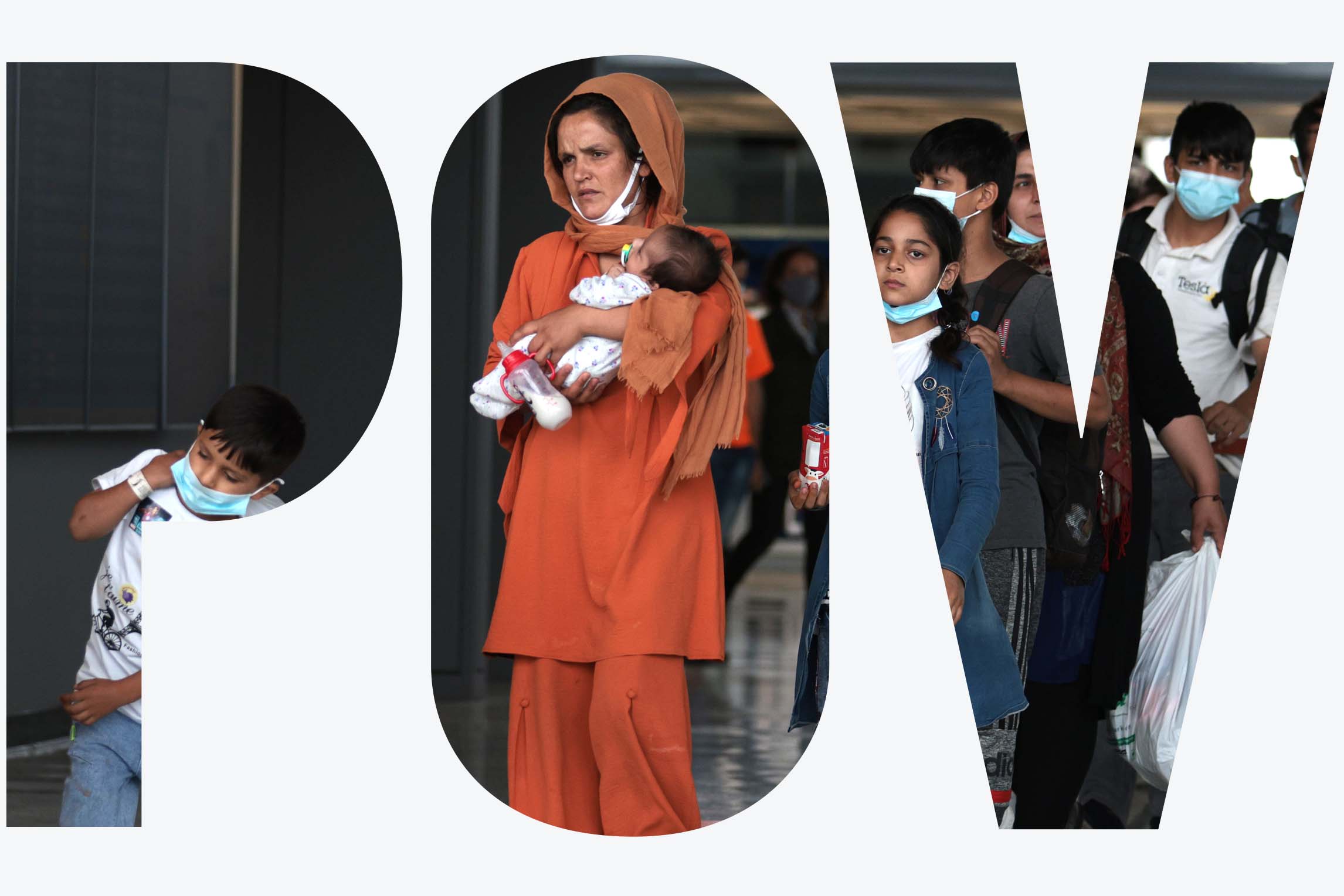 Afghan Refugees walk through the departure terminal to a bus at Dulles International Airport after being evacuated from Kabul following the Taliban takeover of Afghanistan.