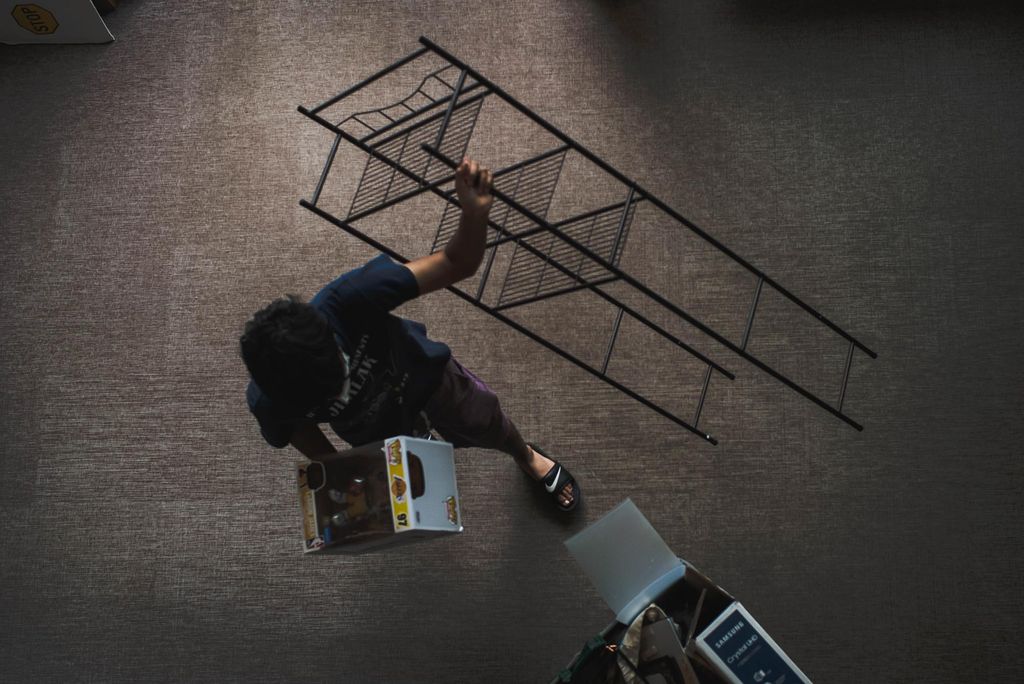 Aerial shot of a student carrying a rack into their dorm.