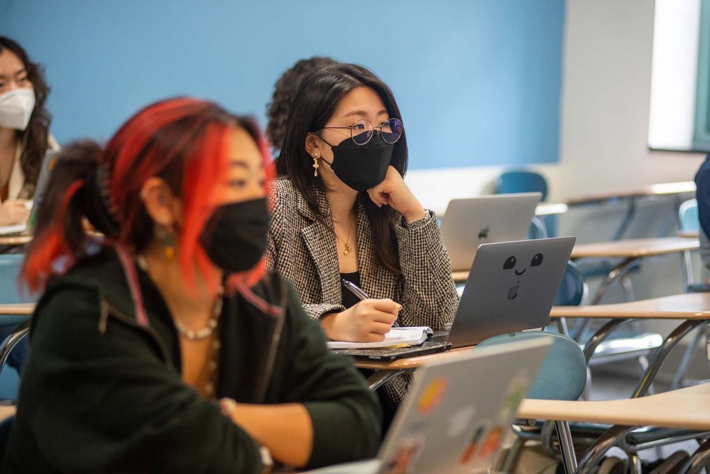 Students wearing face coverings listen to associate professor Yoon Sun Yang’s Major Authors in Korean Literature class lecture, September 2 at the Boston University College of Arts and Sciences.