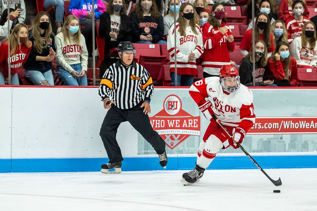 Robert Mastrosimone skates by a referee as he fires off a shot on goal during a victorious exhibition game against Holy Cross.