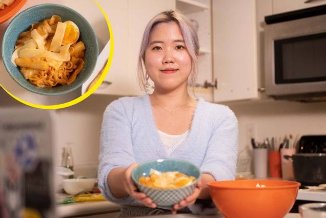 Photo of Sophie Lee (Questrom’22), wearing a light blue sweater and smiling, as she holds a teal bowl of Tteokbokki in front of her. Overlaid on the photo at the top left is a top-down view of the bowl of Tteokbokki, which has noodles, a reddish sauce and a soft-boiled egg.