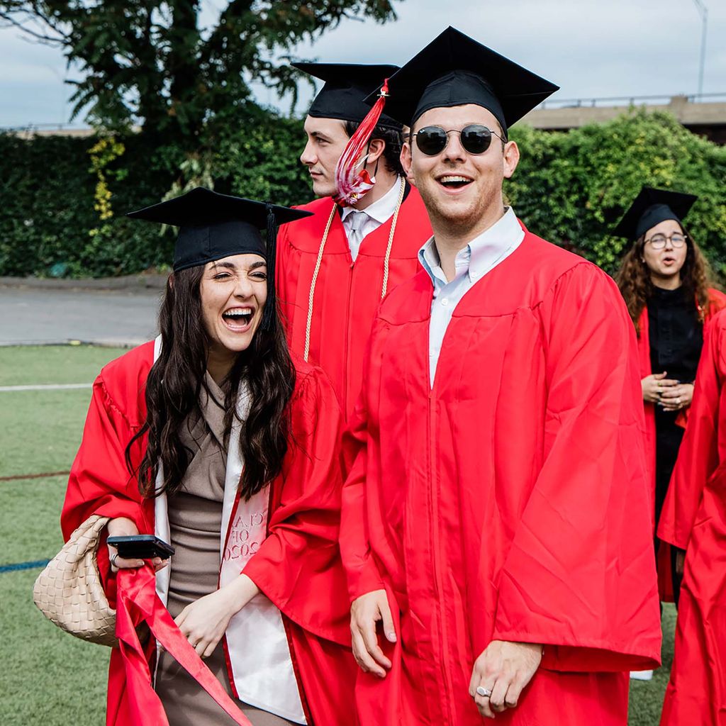 Students laugh while celebrating on Nickerson Field following BU's Class of 2020 Commencement.