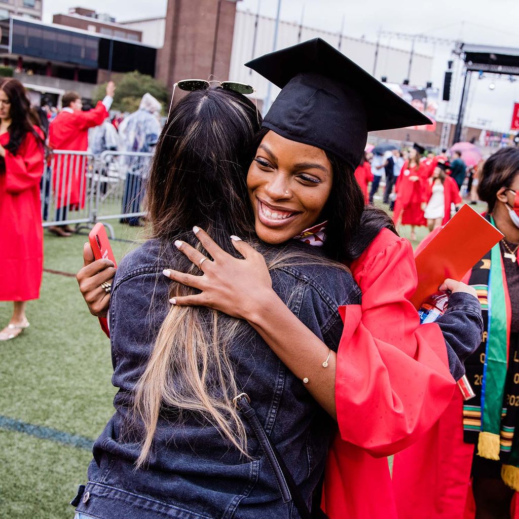 A graduating student hugs a family member or friend following Boston University's Commencement for the Class of 2020.