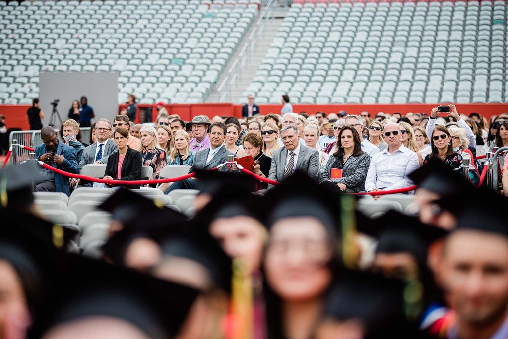 View of spectators behind graduating students of the Boston University Class of 2020 during Commencement.