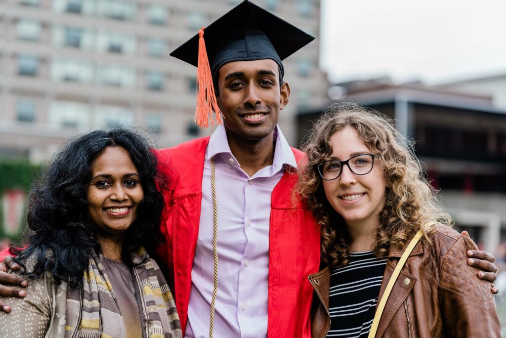 A BU Class of 2020 graduate poses for a photo with family or friends following Commencement.