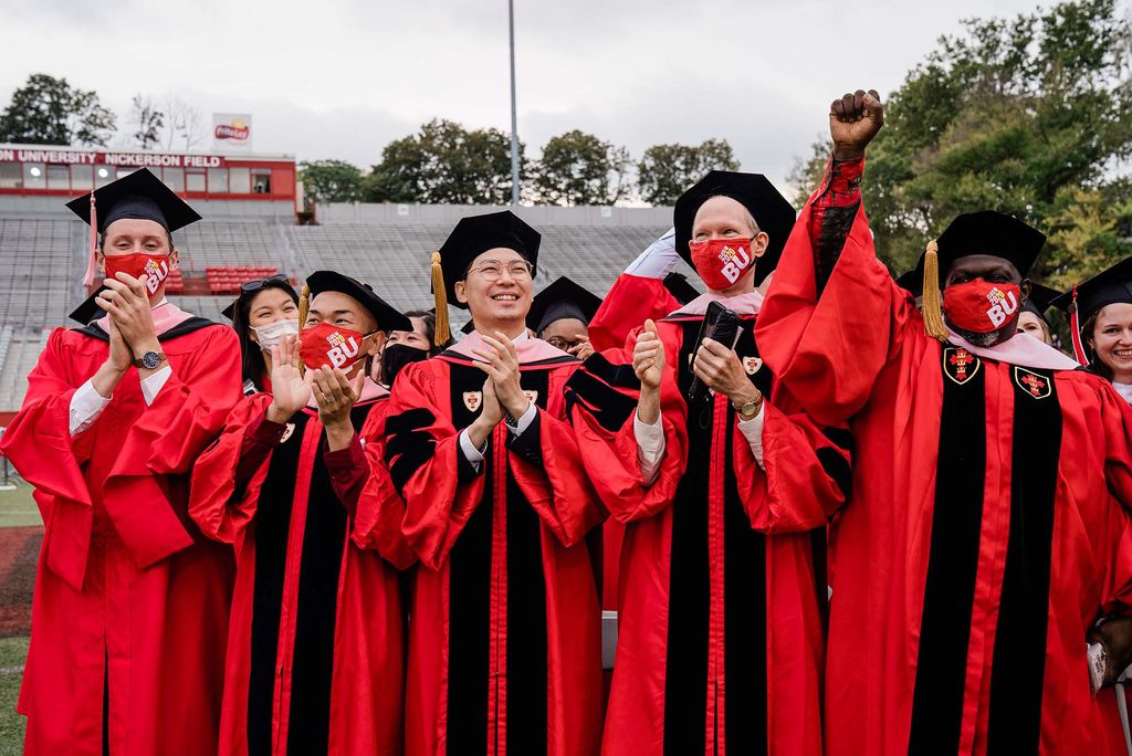 A row of graduate students cheer during the Class of 2020 Commencement at Boston University.