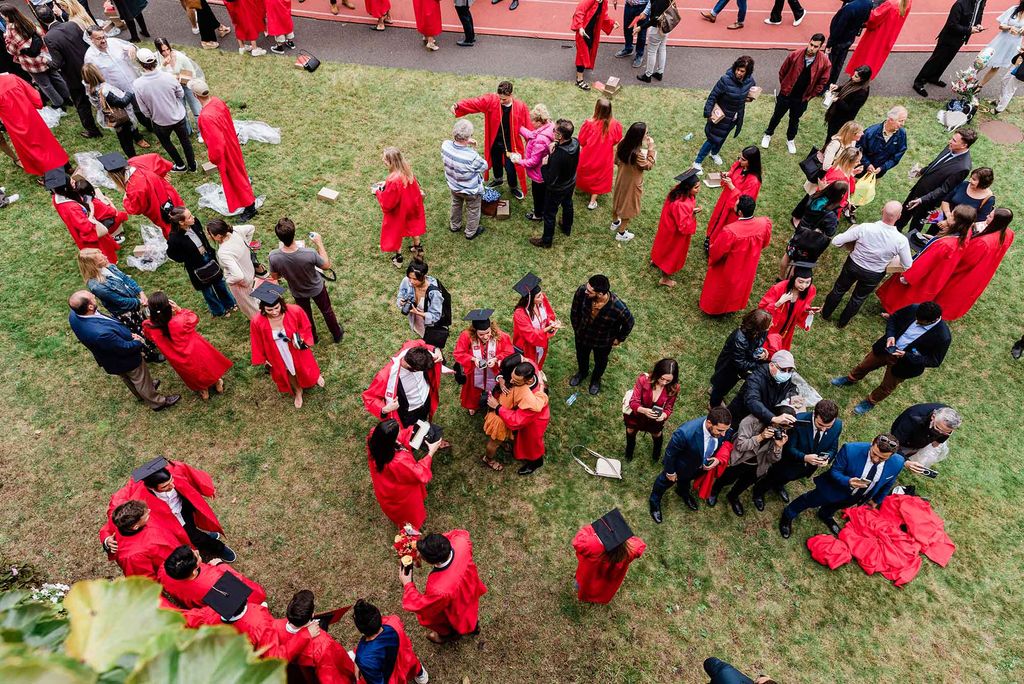 Graduating students and family congregate on Nickerson Field following Boston University's 147th COmmencement ceremony.