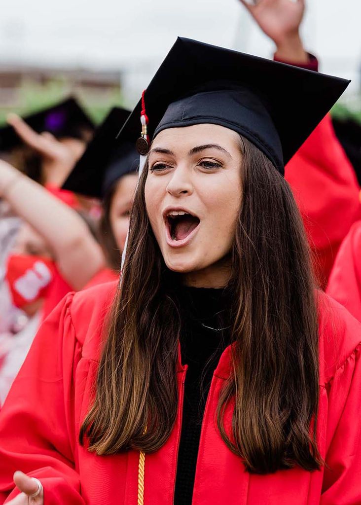 Class of 2020 students cheer during Boston University's 147th Commencement ceremony on Nickerson Field.