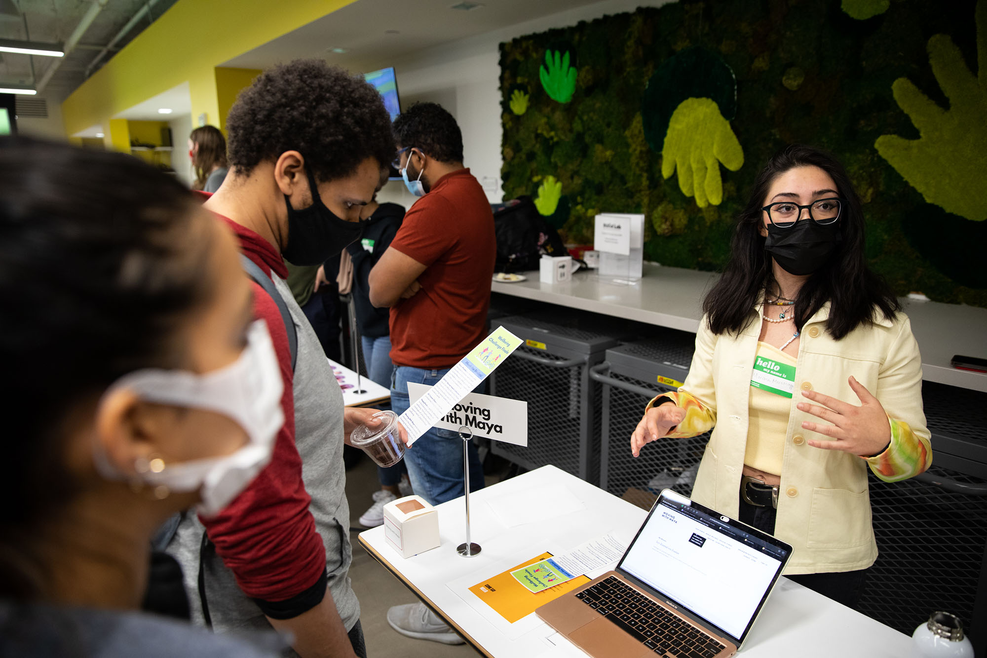 Mariana Mezzacappa (Sargent’25) talks about her project, Moving with Maya, a health based initiative to help those with disabilities work out while Stedmon Sweeney (ENG’23), second from left, and Natalia Shilotri (Questrom’22) look on during the Innovate@BU’s second annual Community Impact Challenge.