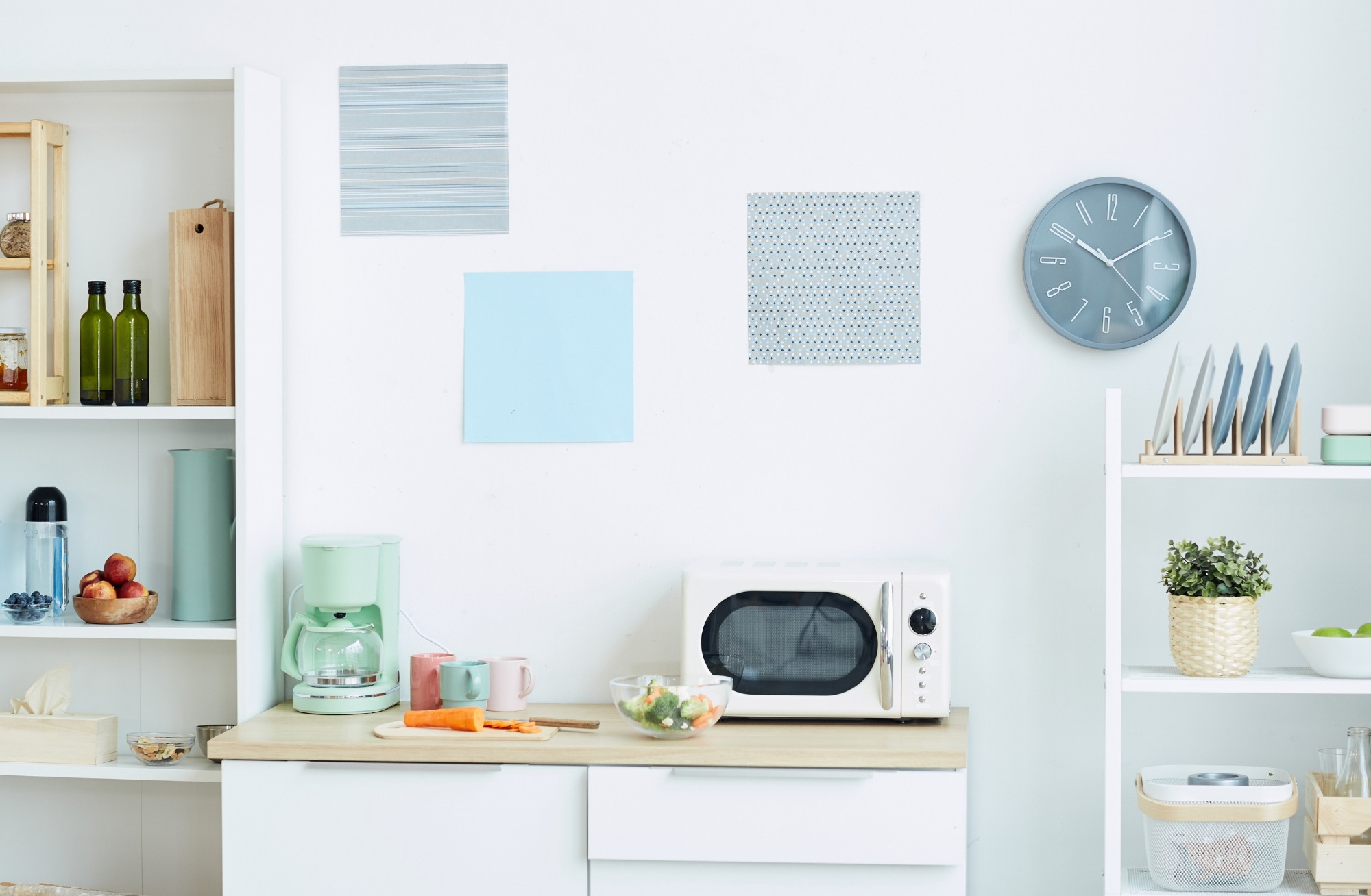 photo of a dorm room kitchen, including a microwave, coffee maker, cutting board, and mixing bowl