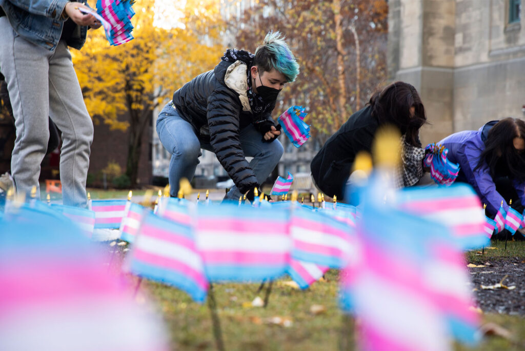 Kaiden Kane (Sargent’21) and treasurer for the Trans Listening Circle, placed trans flags in remembrance of those 375 LGBTQIA+ people reported murdered internationally within the last year. The group placed 400 flags on Alpert Mall, Friday, November 19, 2021 for Transgender Day of Remembrance on Saturday, November 20th. Photo by Jake Belcher