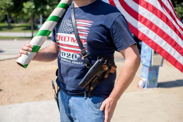 Photo of Kenny Wolfam open carrying a pistol and wears a "Trump 2020" t-shirt while counter-protesting a "Moms Demand Action" protest in response to a new Texas gun law at Buffalo Bayou Park in Houston, Texas on June 17, 2021.