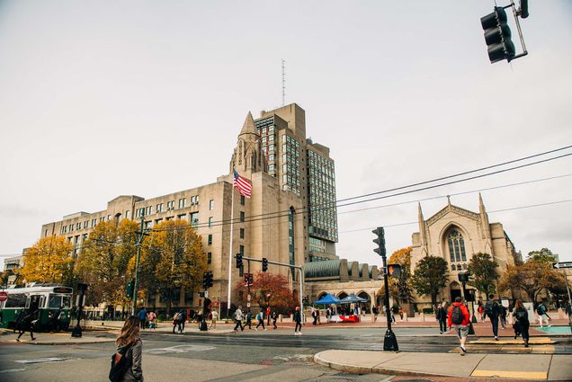 Photo of the GSU and Marsh Plaza on an overcast fall day. Students walk to class and the American flag blows in the wind.