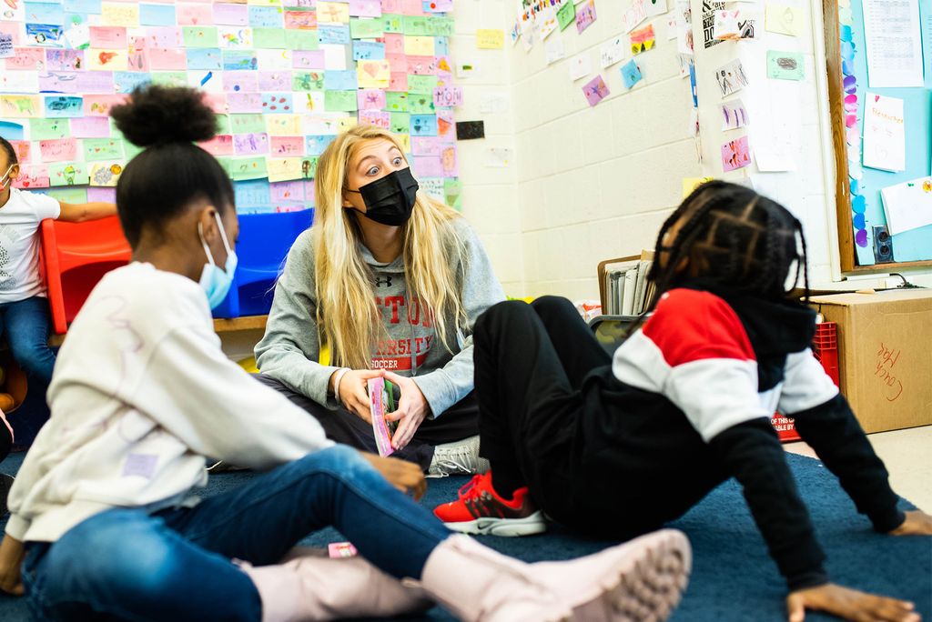 BU soccer player, Claire Orson (Questrom 22) reads books to students at Blackstone Elementary School on Monday, December 13, 2021. Photo by Jackie Ricciardi for Boston University