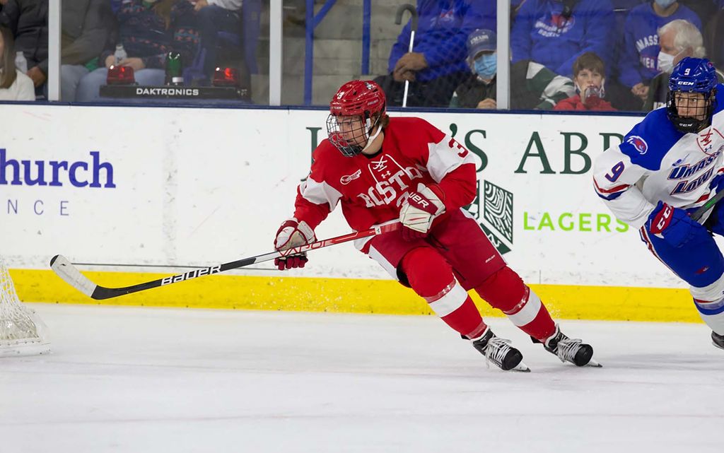 Photo of Tristan in a red jersey on the ice during a game against UMass Lowell.