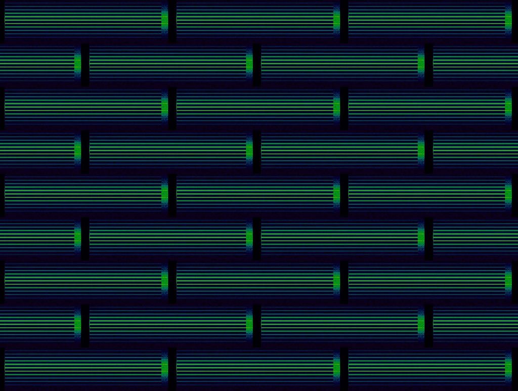 Photo of a series of pipes lined up with one another. The pipes are light green and rest on a dark blue background.